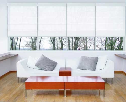 White set of 4 roman blinds for consecutive windows with partial opacity